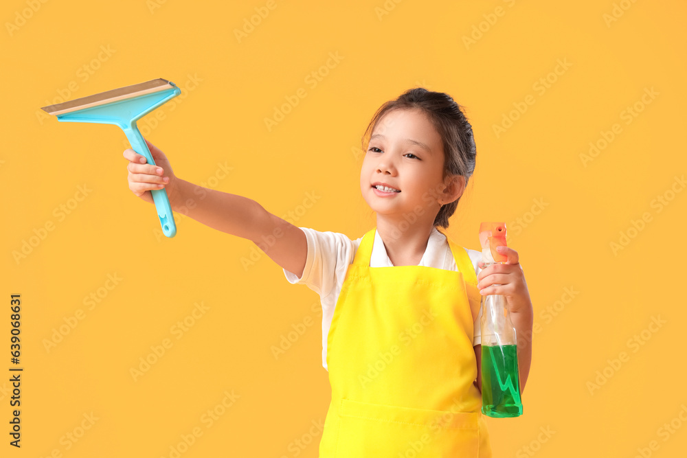 Cute little janitor with squeegee and detergent on yellow background Cute little janitor with squeegee and detergent on yellow background