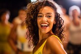Portrait of a beautiful young woman with curly hair smiling at the camera.