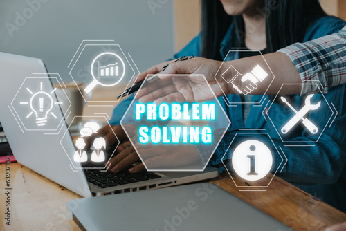 Problem solving concept, Business team working on laptop compuer on desk with problem solving icon on virtual screen.