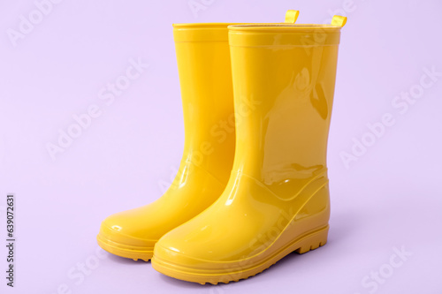 Yellow gumboots on lilac background