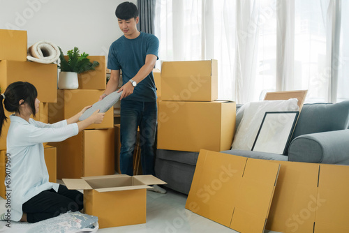 Young married couple moving into new home.