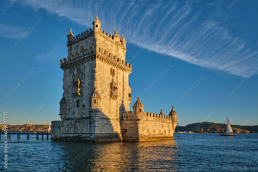 Belem Tower or Tower of St Vincent - famous tourist landmark of Lisboa and tourism attraction - on the bank of the Tagus River Tejo on sunset. Lisbon, Portugal with tourist yacht boat