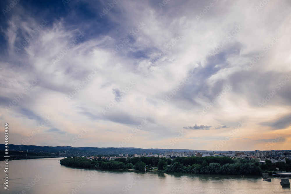 View of the Danube River and the city of Novi Sad, Serbia against the background of an amazing cloudy sky during sunset