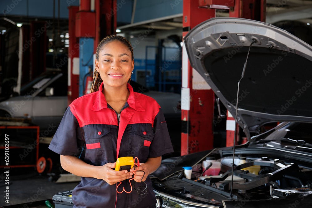 One Black female professional automotive mechanical worker checks an EV car battery and hybrid engine at a maintenance garage, expert electric vehicle service, and fixing occupations auto industry. One Black female professional automotive mechanical worker checks an EV car battery and hybrid engine at a maintenance garage, expert electric vehicle service, and fixing occupations auto industry.