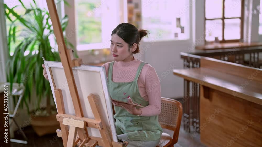Asian woman artist working on painting brush on canvas and variant acrylic color in her art studio, Artist creative concept. Asian woman artist working on painting brush on canvas and variant acrylic color in her art studio, Artist creative concept.