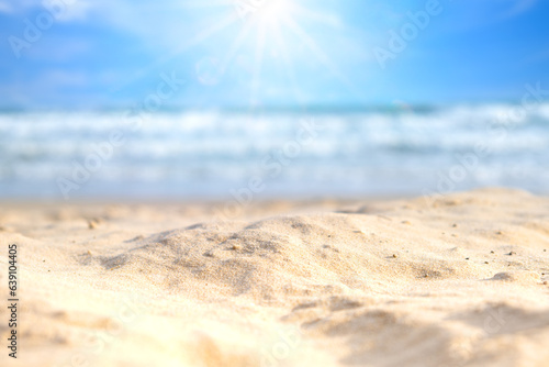 Beach sand background for summer vacation concept. Beach nature and summer seawater with sunlight light sandy beach Sparkling sea water contrast with the blue sky