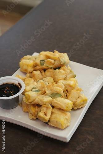 Tahu kemu lor fried tofu  on plate. Tahu kemul is traditional snack from sundanese, Indonesia. Eat with soy sauce photo