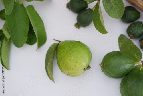 Fresh guava fruit in a basket on white background. Selective focus.