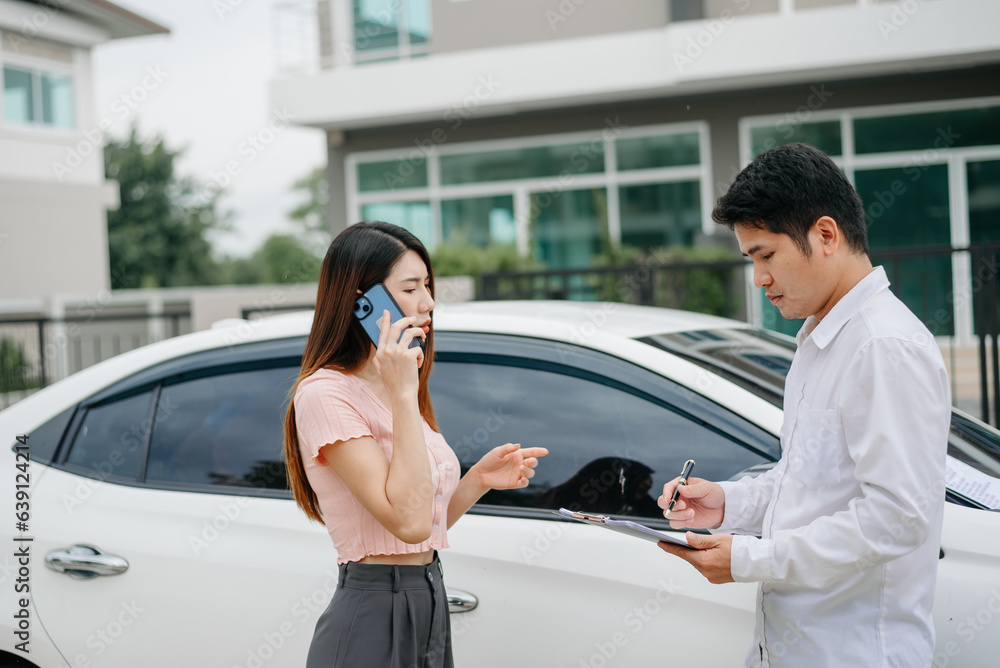 Woman and insurance agent claims process after car crash. with an Asian male Insurance Adjuster. Woman and insurance agent claims process after car crash. with an Asian male Insurance Adjuster.