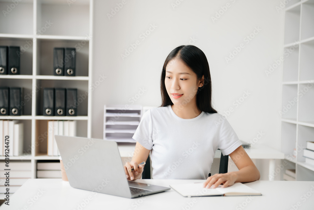Business woman using tablet and laptop for doing math finance on an office desk, tax, report, accounting, statistics, and analytical research concept in office Business woman using tablet and laptop for doing math finance on an office desk, tax, report, accounting, statistics, and analytical research concept in office