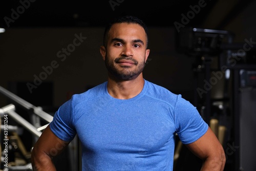 Portrait of a strong Hispanic man at a gym looking at camera.