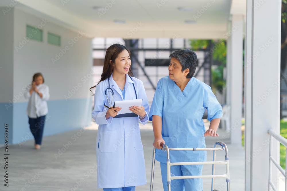 Smiling pretty caregiver and old lady with walking at hospital. concept healthcare. Smiling pretty caregiver and old lady with walking at hospital. concept healthcare.