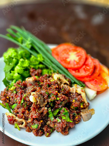 Thai Food, Isaan Food Dishes Larb Koi. Raw Beef Spicy Salad. Northeastern Thai Dishes. Raw meat mixed with spices is spicy. photo