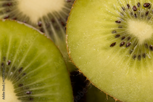 Micro close up of sliced kiwi fruit and copy space on black background