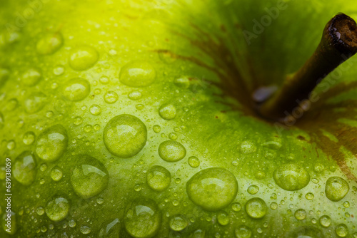 Micro close up of green apple with water drops and copy space