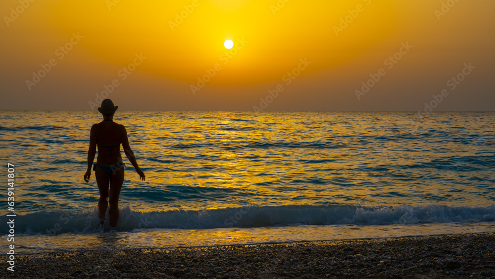 woman looking out to a gorgeous sunset