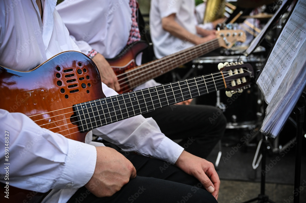 musical orchestra in the foreground electric guitar