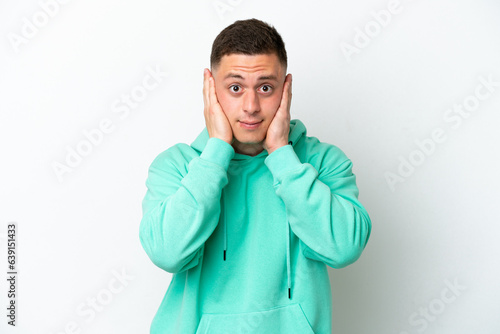 Young brazilian man isolated on white background frustrated and covering ears