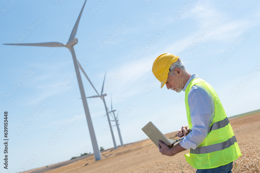 Engineer using laptop for wind turbine inspection Engineer using laptop for wind turbine inspection