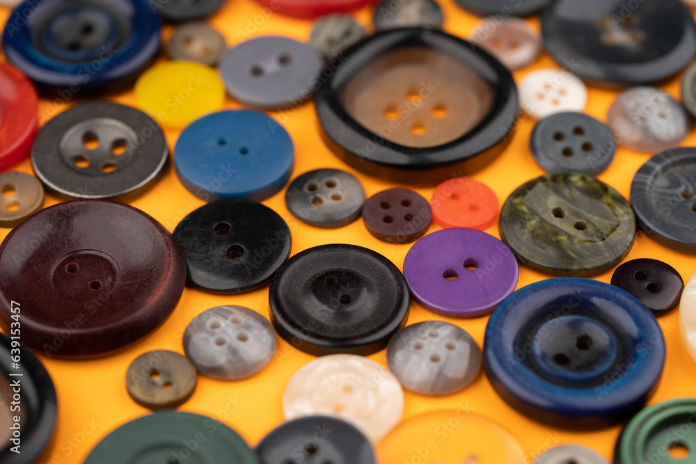 Many different buttons on a yellow background Many different buttons on a yellow background