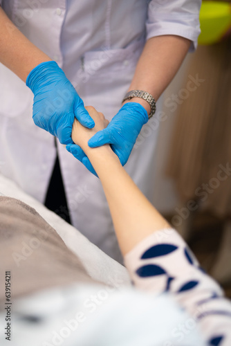 close-up of a massage therapist doing a hand massage in a beauty salon