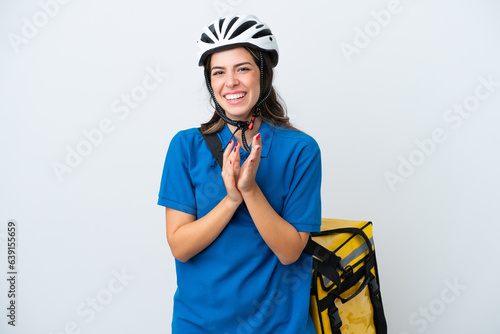 Young delivery woman with thermal backpack isolated on white background applauding after presentation in a conference