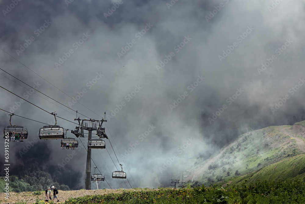 Obraz premium Cabins of cable car funicular in thick white fog.