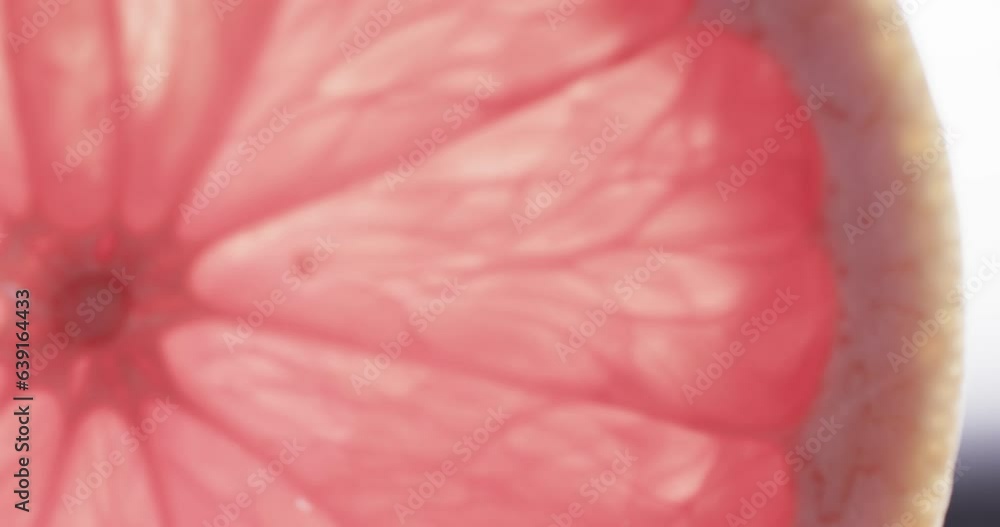 Micro video of close up of red grapefruit slice with copy space Micro video of close up of red grapefruit slice with copy space