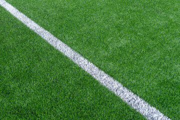 Green synthetic grass sports field with white line shot from above. Soccer, hurling, lacrosse, rugby, football, baseball sport concept