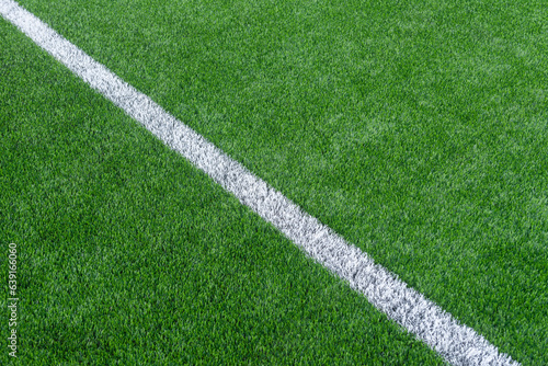 Green synthetic grass sports field with white line shot from above. Soccer, hurling, lacrosse, rugby, football, baseball sport concept
