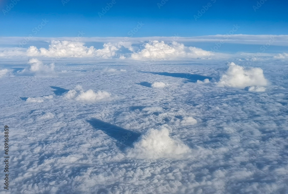 Fototapeta premium White clouds in the troposphere. Scenery Seen from an airplane in flight.