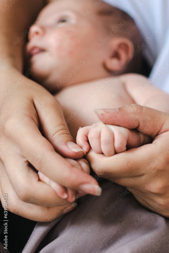 a small child is sleeping in his mother's arms. a newborn baby. mom's daughter. parenthood. childhood a small child is sleeping in his mother's arms. a newborn baby. mom's daughter. parenthood. childhood