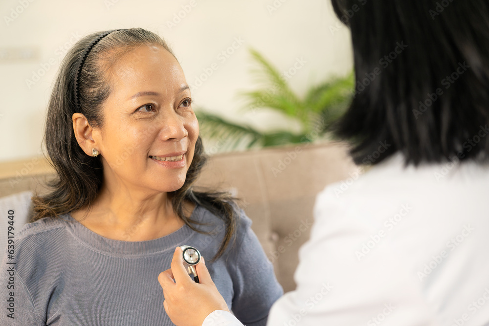 Doctor examining heart with stethoscope and talking to senior woman at clinic for annual checkup and health insurance concept. Doctor examining heart with stethoscope and talking to senior woman at clinic for annual checkup and health insurance concept.