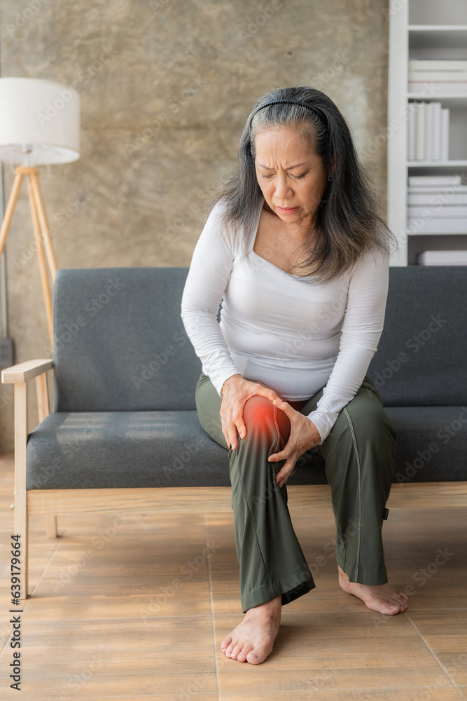 Knee pain, Asian senior woman close up Mature senior woman touching