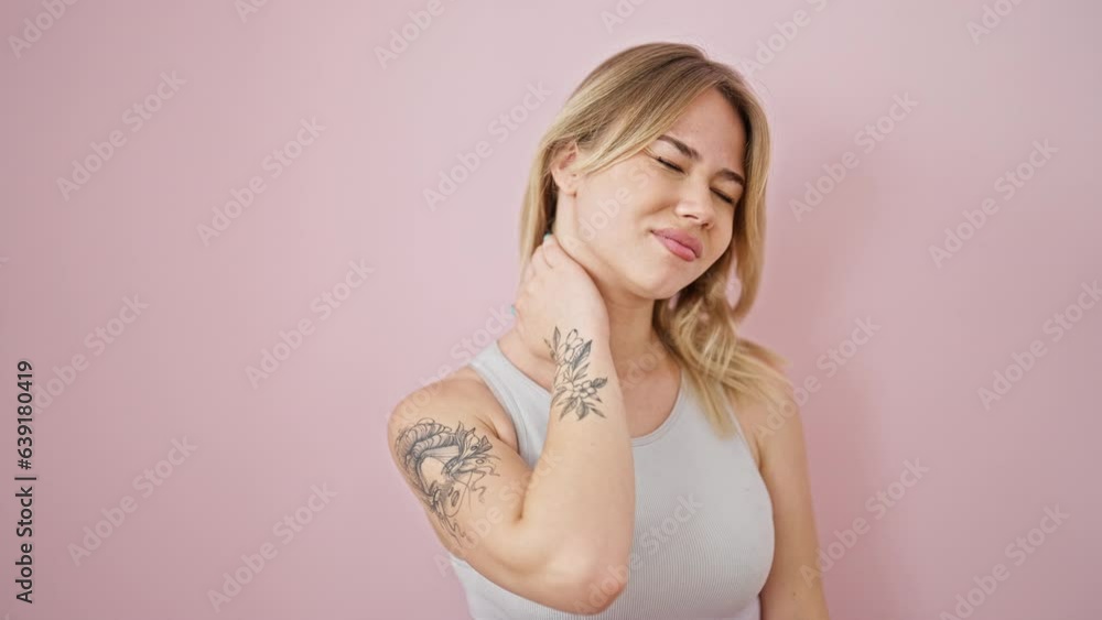 Young blonde woman suffering for cervical pain over isolated pink background Young blonde woman suffering for cervical pain over isolated pink background