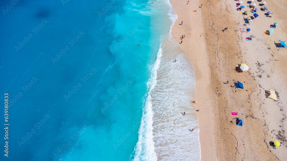 Aerial drone aerial shot in summer on paradise sandy beach Megali Petra in Lefkada. Beautiful crystal clear turquoise and blue waters. Greece