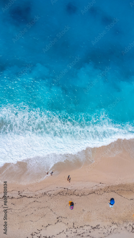 Aerial drone aerial shot in summer on paradise sandy beach Megali Petra in Lefkada. Beautiful crystal clear turquoise and blue waters. Greece. vertical photo Aerial drone aerial shot in summer on paradise sandy beach Megali Petra in Lefkada. Beautiful crystal clear turquoise and blue waters. Greece. vertical photo