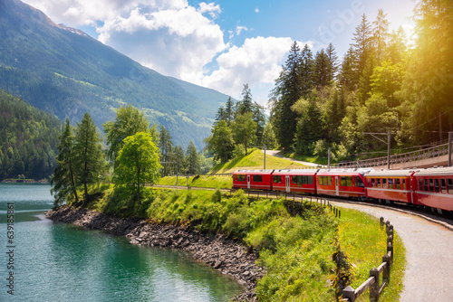 Quadro su tela Train going along lake in Switzerland in summer