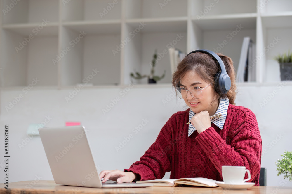 Asian female student study online in class, study online, wearing headphones, watching video call, zooming, happy asian female learning language online with computer laptop. Asian female student study online in class, study online, wearing headphones, watching video call, zooming, happy asian female learning language online with computer laptop.