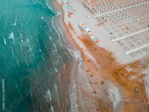 Aerial view of the beach of the Romagna Riviera with Rimini in the Emilia Romagna region. Rimini beach on sunny summer day. 