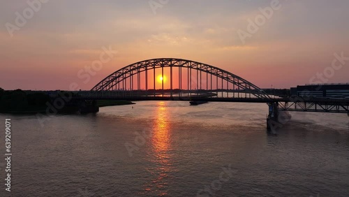 orange sun rising above the River Noord and the Hendrik ido Ambacht bridge photo