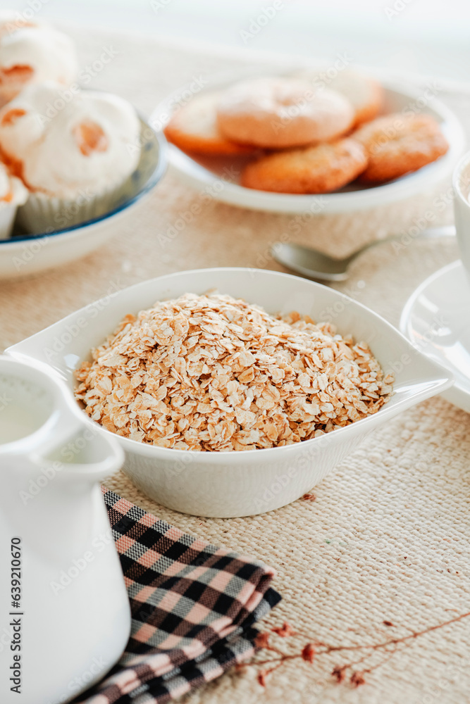 rolled oats, plant milk and cookies on a table rolled oats, plant milk and cookies on a table