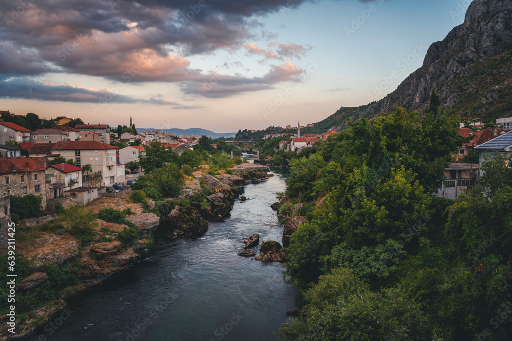 Majestic evening view of Mostar with the Mostar Bridge, houses and minarets, at evening. Travel to Balkans and Bosnia