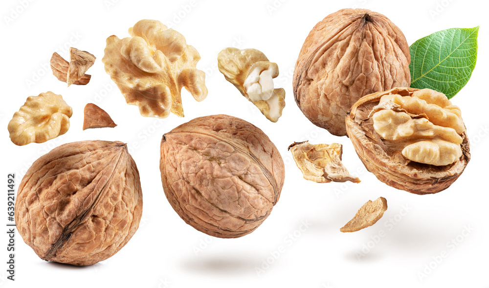 Whole walnuts and walnut kernels levitating in air on white background. Whole walnuts and walnut kernels levitating in air on white background.
