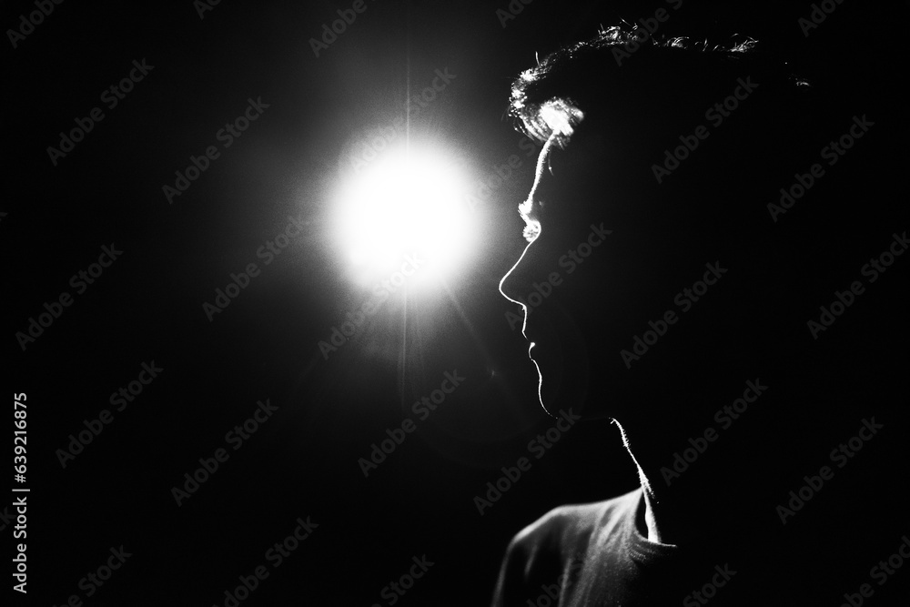 black and white silhouette portrait of a young guy on a black ...