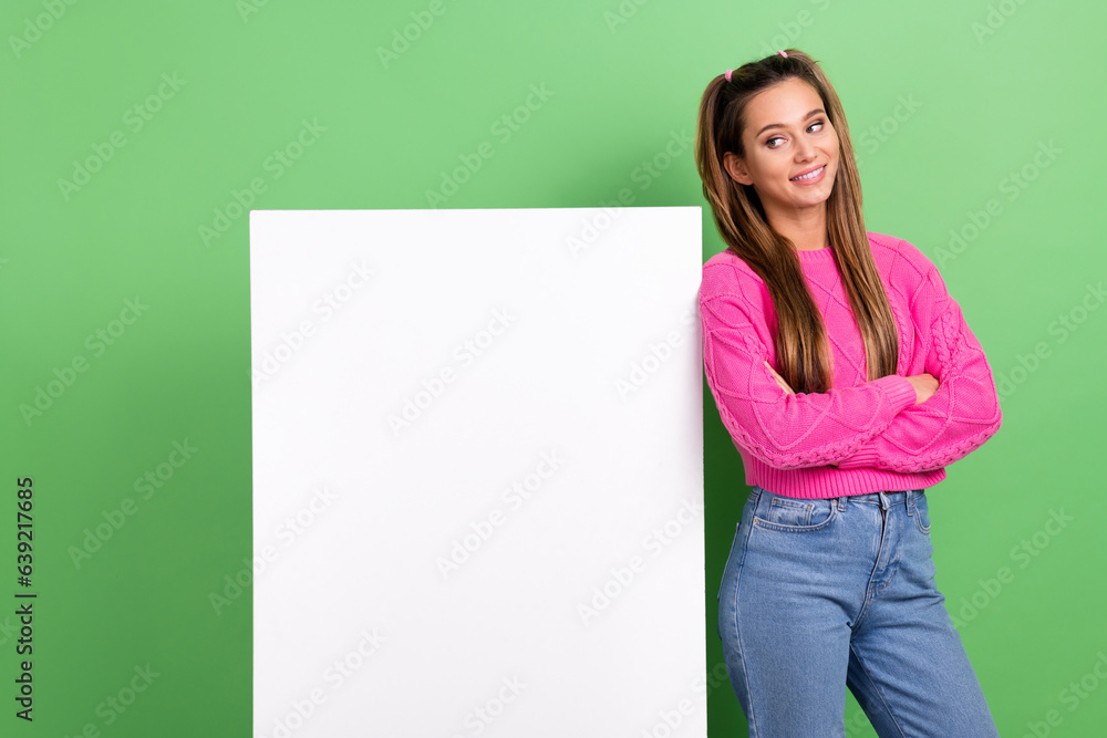 Portrait of adorable pretty nice girl wear knit pullover look at billboard empty space palms folded isolated on green color background Portrait of adorable pretty nice girl wear knit pullover look at billboard empty space palms folded isolated on green color background