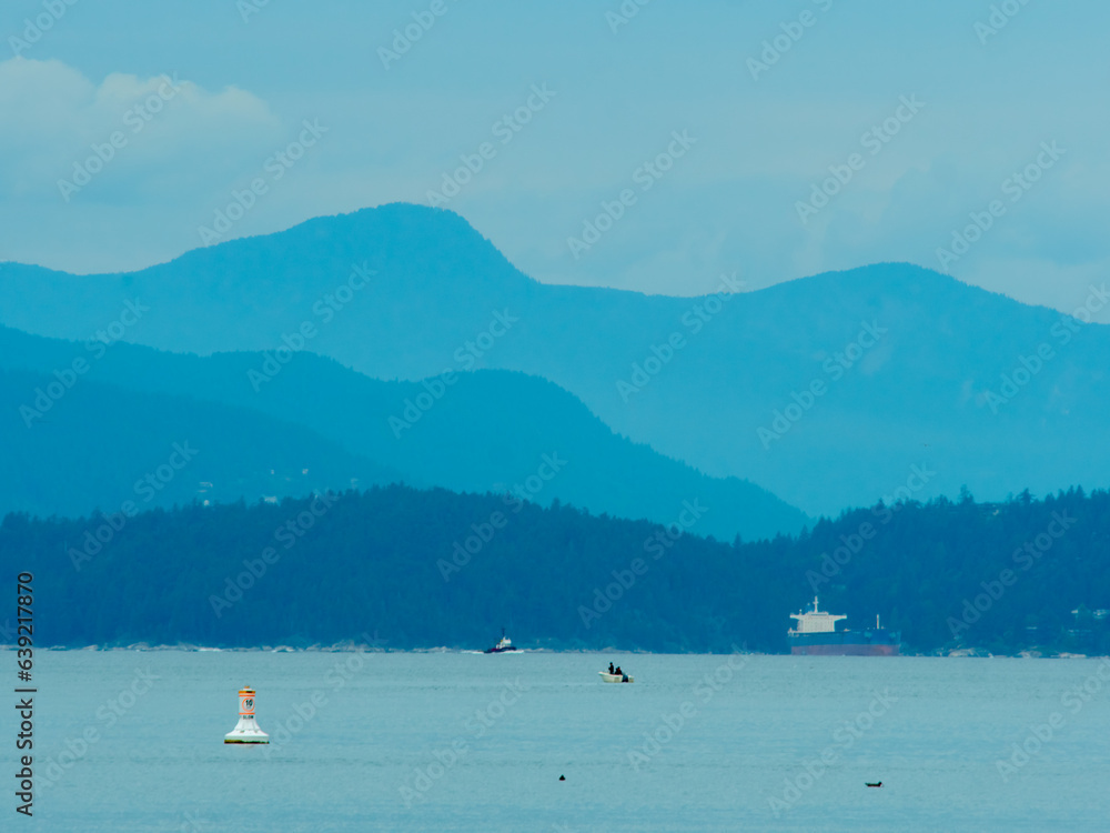 English bay in Vancouver during a cloudy day with the ocean and mountains as a view