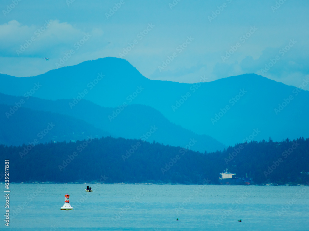 Low Contrast Blue background with mountains and a sky with clouds
