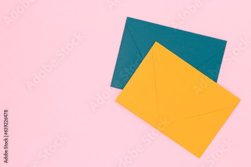 Free Download Multicolored envelopes on a pink background. Minimal composition with copy space. - GFXLoad