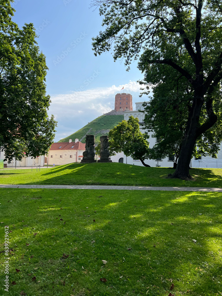 Vilnius, Lithuania - 08.06.2022: Stone idols and a tower in the center of Vilnius, Gediminas Castle Tower. Vilnius, Lithuania - 08.06.2022: Stone idols and a tower in the center of Vilnius, Gediminas Castle Tower.